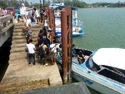 boarding the boat to Koh Mak at the krom luang pier in Laem Ngop